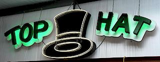 Neon "Top Hat" sign, Hat is white neon 50" x 52", accompanying  Top Hat lettering 27" x 54" is back-lit with green neon