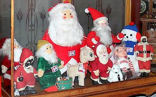Group of advertising dolls and Santas