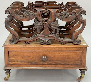 Rosewood Victorian canterbury with pierce work separators and one drawer on brass capped feet. ht. 18in., wd. 21in., dp. 15in