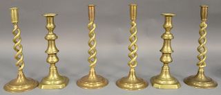 Three pairs of brass candlesticks including two pairs of English Barley twist candlesticks and a pair of large brass push-up 