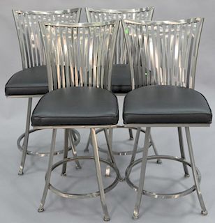Set of four polished chrome back swivel bar stools with black leather seats. ht. 42in., seat ht. 25 1/2in.