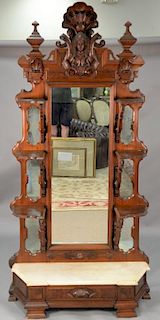 Large Victorian walnut hall mirror with carved shell over bust having large mirror flanked by three shelves on each side, ove