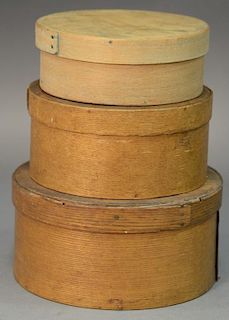 Nest of three round covered pantry boxes. dia. 6in., 6 3/4in., & 7 3/4in.
