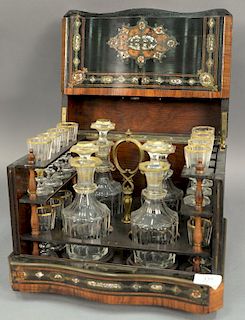 French inlaid tantalus, inlaid mahogany, ebonized wood, brass and mother of pearl, serpentine front opening to four bottles (