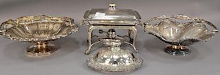 Four silverplated items to include a covered sweet meat dish on warming stand, two flower baskets with handles (dia. 12in.&13