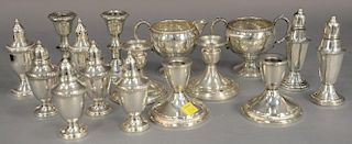 Sixteen pieces of sterling silver, weighted small dishes, salts, creamer and sugar, candlesticks, etc.