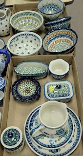 Three tray lots of handmade Polish pottery, twenty-two pieces including bowls, serving dishes, plates, creamer, sugars, etc, 
