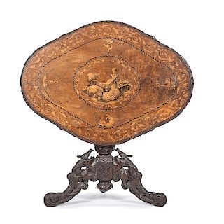 An Elaborately Carved and Marquetry Inlaid Black Forest Inlaid Tilt Table