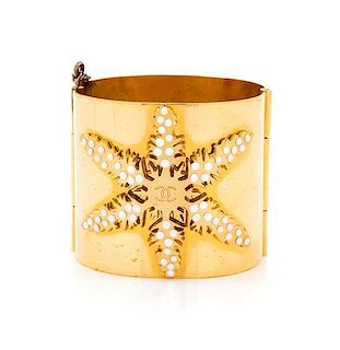 A Chanel Goldtone Snowflake Cuff Bracelet, 2.5" diameter.