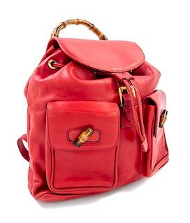 A Gucci Red Leather Bamboo Sac Backpack, 13.5" x 13" x 4"; Bamboo handle drop 3".