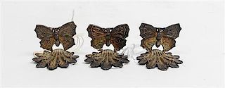 A Set of Three Chinese Silver Place Card Holders, , decorated in the form of butterflies on a shell-form base.