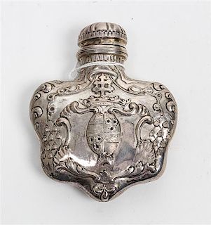 A French Silver Scent Flask, makers mark obscured, the body decorated with a repousse coat of arms of a Bishop.