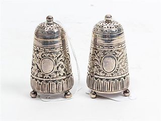 A Pair of Victorian Silver Casters, Edward Hutton, London, 1883, the knopped finial surmounting a domed conical body decorate