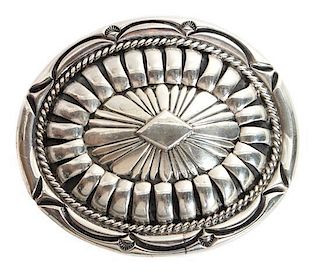 A Navajo Stamped Silver Belt Buckle, Orville Tsinnie (1943-2017) Height 2 5/8 x width 3 1/4 inches.