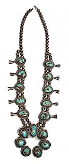 A Navajo Silver and Turquoise Squash Blossom Necklace Length 24 inches.