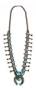 A Navajo Silver and Turquoise Squash Blossom Necklace Length 12 inches; naja 2 1/4 inches.