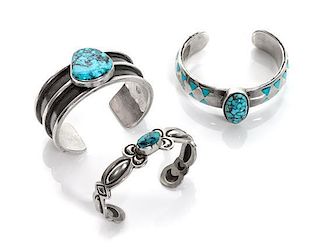 Three Silver and Turquoise Cuffs Length of the first 5 3/8 x opening 1 x width 5/8 inches.