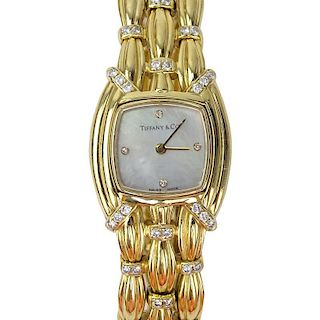Tiffany & Co 18 Karat Yellow Gold and Diamond Signature Bracelet Watch, Mother of Pearl Dial, Swiss Automatic Movement.