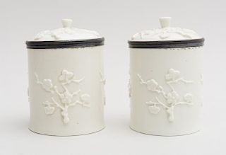 PAIR OF FRENCH RELIEF-DECORATED PORCELAIN TOBACCO JARS AND COVERS