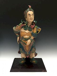 A CHINESE ANTIQUE POLYCHROME DECORATED FIGURE