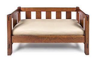 * Arts and Crafts, FIRST QUARTER 20TH CENTURY, an oak settee, of rectangular form with vertical splats and upholstered seat