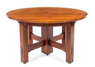 * Gustav Stickley, (American, 1858-1942), an oak extension table, model no. 634, having a circular top expanding to oval, rai