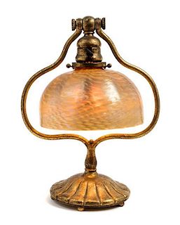 * Tiffany Studios, EARLY 20TH CENTURY, a gilt bronze and Favrile glass desk lamp