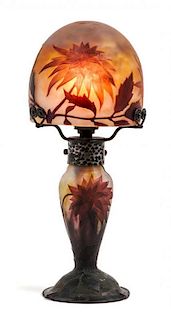 * Daum, EARLY 20TH CENTURY, a cameo glass boudoir lamp, the domed shade and baluster form base with flower and leaf decoratio
