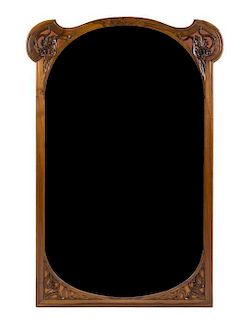 * An Art Nouveau Walnut Pier Mirror, Height 64 x width 43 1/4 inches.
