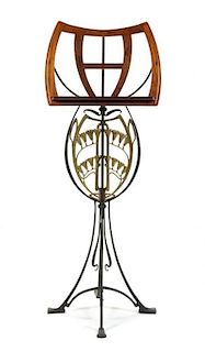 * A Belgian Art Nouveau Wrought Iron and Walnut Music Stand, Height 50 1/2 inches.