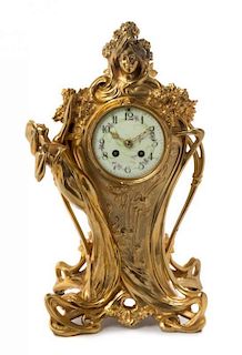 * An Art Nouveau Gilt Metal Mantle Clock, Height 18 inches.