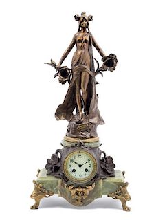 * An Art Nouveau Cast Metal and Onyx Figural Mantle Clock, Height 24 3/4 inches.