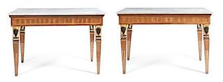 A Pair of Italian Empire Style Black Painted and Parcel Gilt Console Tables, Height 38 3/4 x width 55 1/4 x depth 27 1/2 inches.