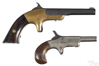 Two side swing spur trigger single shot pistols