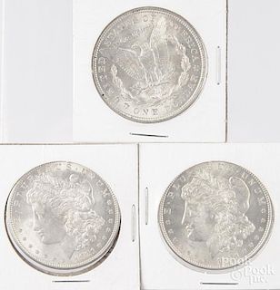 Three 1921 Morgan silver dollars.