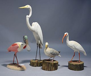 Four carved wooden shorebirds