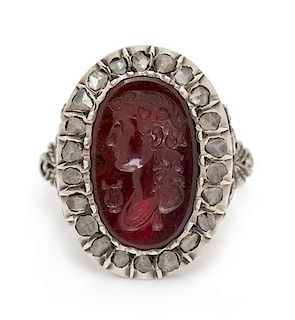 * A Victorian Silver Topped Yellow Gold, Carnelian Intaglio and Diamond Locket Ring, 4.30 dwts.