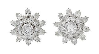 A Pair of 18 Karat White Gold and Diamond Floral Cluster Earclips, 8.80 dwts.