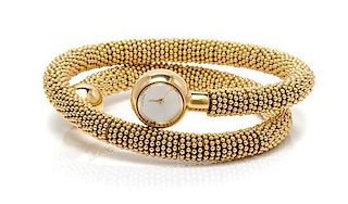 An 18 Karat Yellow Gold 'Couscous' Wrap Bangle Wristwatch, Van Cleef & Arpels, 108.50 dwts.