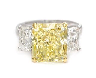 A Platinum, 18 Karat Yellow Gold, Fancy Yellow Diamond and Diamond Ring, 4.90 dwts.