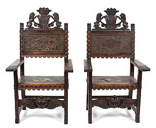 A Pair of Renaissance Revival Carved Oak Armchairs Height 53 inches.