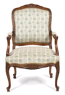 A Louis XV Style Carved Walnut Fauteuil