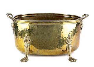 An English Hammered Brass Footed Jardiniere Height 9 1/2 x width 19 1/2 x depth 11 1/2 inches.