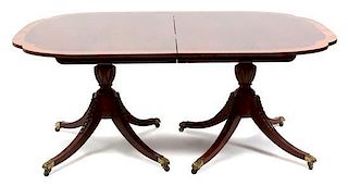 A George III Style Inlaid Mahogany Pedestal Dining Table Height 29 x length closed 66 x width 46 inches.