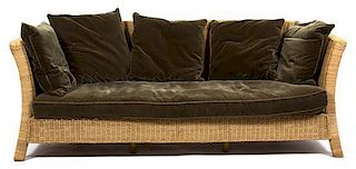 A Wicker Sofa with Velvet Seat and Back Cushions Height 35 x width 89 x depth 44 inches.