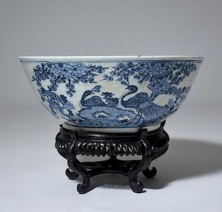 A large Chinese blue and white porcelain bowl on stand