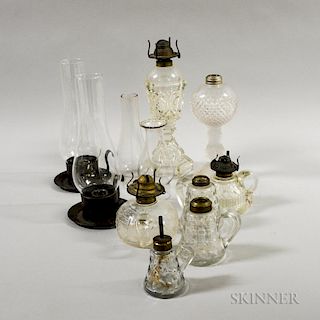 Nine Colorless Pressed Glass Lighting Devices, 19th century, including an El Dorado with pressed hearts and one with pressed
