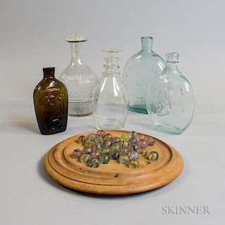 Five Glass Bottles and Flasks, a Set of Marbles, and a Game Board, including an amber eagle flask, two aqua "Gen Taylor Never