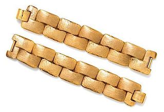 A Pair of Robert Goossens Goldtone Bracelets, 7.5" x 1.5".
