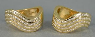 Pair of 14K gold and diamond earrings, each set with four rows of diamonds. 15.8 grams.